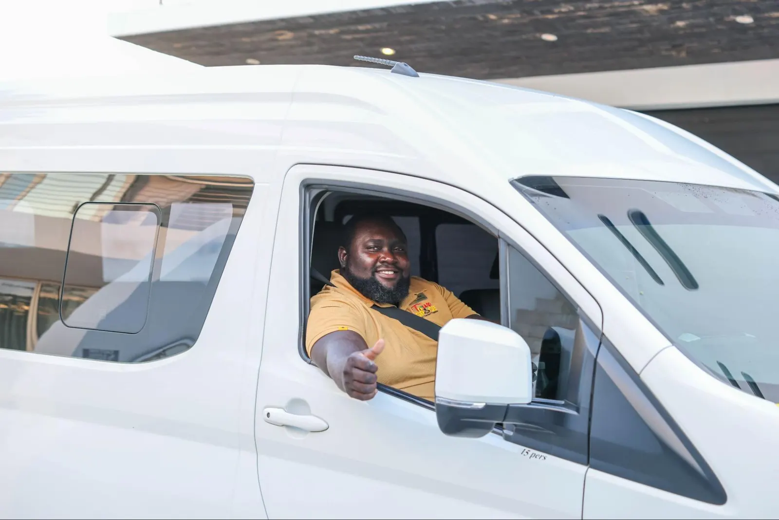 Collie, Tour De Spice nature and birdwatching guide, giving a thumbs up from a tour van